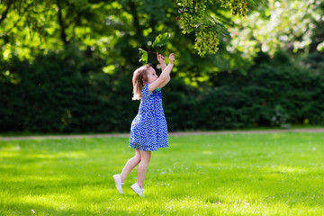 Little girl running in sunny park