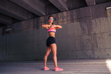 Fit woman runner stretching outdoors
