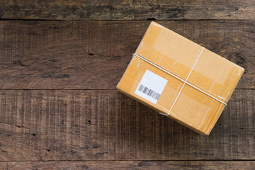 cardboard box taped up on wooden table with copy space.