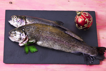 Trout on the plate with holiday decoration
