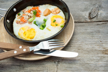 pan egg on wooden table, breakfast