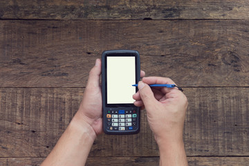 Human hand using tablet barcode scanner.
