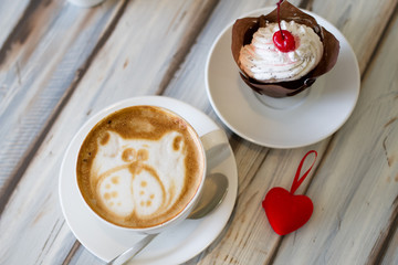 Cup of coffee cappuccino with cupcakes