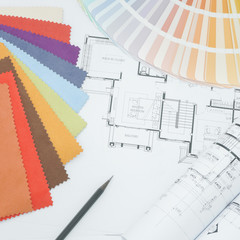 Interor designer working table with drawing, sample fabric and color palette