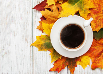 Cup of coffee and autumn leaves