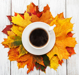 Cup of coffee and autumn leaves