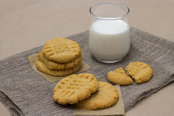 Healthy peanut butter cookies with milk on a linen napk