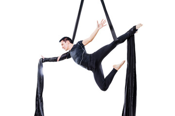 man hanging in aerial silk, isolated on white