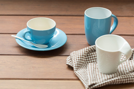 Blue and white coffee cups on wooden table