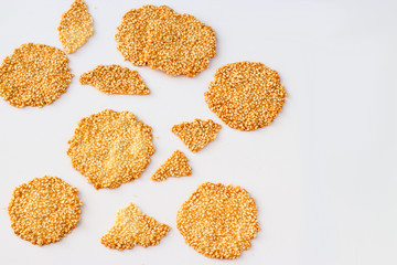 Healthy sesame crisps on light background