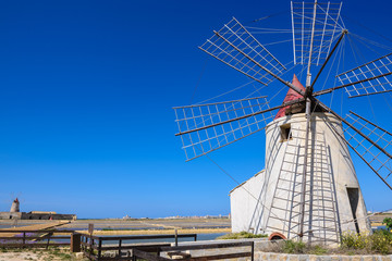 The salt flats with a windmill of Trapani, Sicily (Italy) - obrazy, fototapety, plakaty