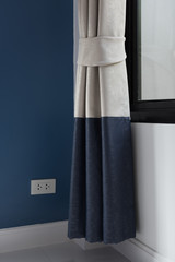 Modern grey  curtains with blue wall background