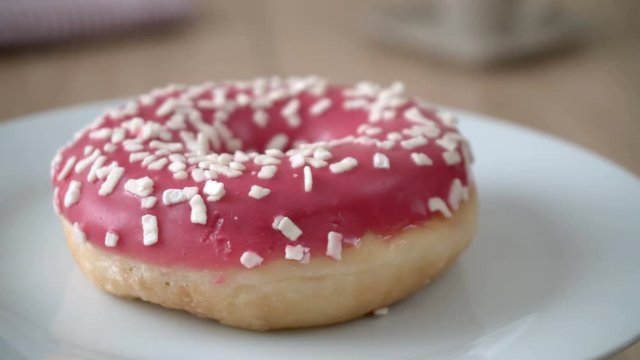 Delicious donut rotating on a plate. Seamless loopable.