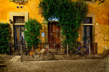 Naklejka na ściany i meble Old street at night in Trastevere, Rome, Italy. Trastevere is rione of Rome, on the west bank of the Tiber in Rome, Lazio, Italy. Architecture and landmark of Rome
