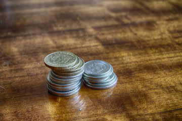 Two stacks of coins of different values on the table