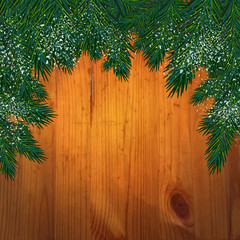 Background with christmas tree branches  in front of a wooden wa