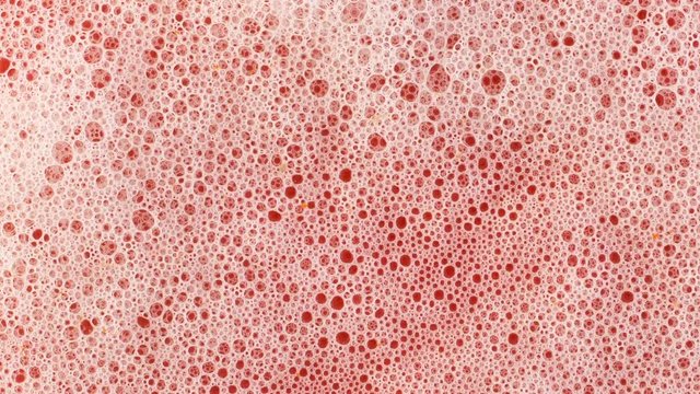 foam on red background macro