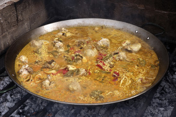 Close up of a paella, cooked on a grill