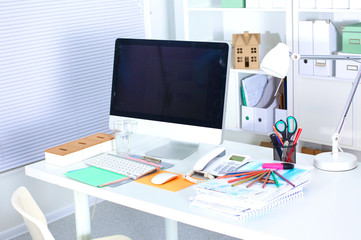 office working desk with computer and paperwork