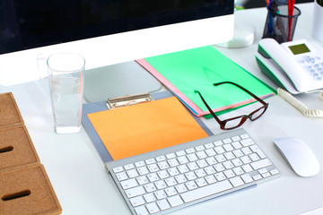 office working desk with computer and paperwork