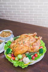 Roasted turkey stuffing garnished with Vegetables served with gravy sauce on a rustic style table. Christmas Dinner