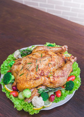 Roasted turkey stuffing garnished with Vegetables served with gravy sauce on a rustic style table. Christmas Dinner