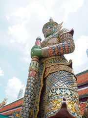 Fototapeta premium big green giant statue stand with sunshine at thailand temple holiday travel trip