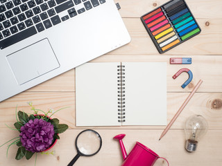 Top view(flat lay) Cup of coffee with notebook on wooden desk.Relaxing time after work