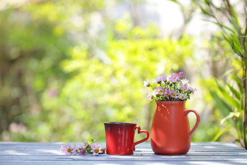 flower in red pot and red cup