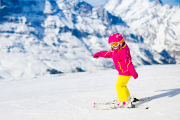 Little child skiing in the mountains