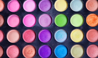 Make-up colorful eyeshadow palettes isolated on black background