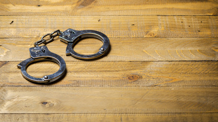 Handcuffs on a wooden table