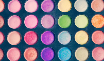 Make-up colorful eyeshadow palettes isolated on black background