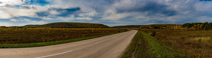 Wide panorama of road and hills, Autumn, Russia