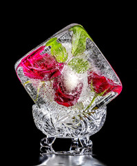 Ice sculpture with red roses on a black background