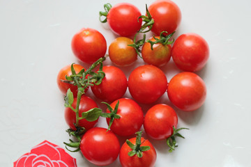 Fresh red tomatoes on the white plate