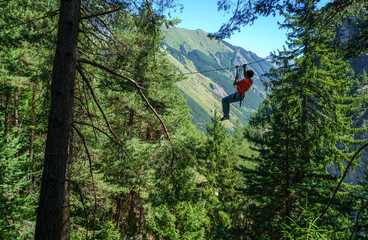 Young playing in canopy in the Alps