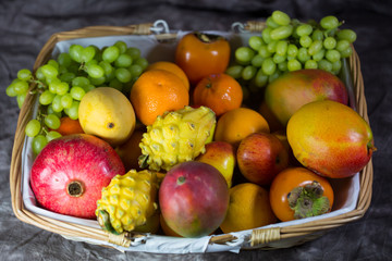Exotic fruit, khaki, mango, pitahaja, pomegranate on a white background - studio