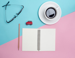 Top view of colorful cup of coffee and glasses  on color blue and pink background for create idea for business or design .Relax coffee time (flat lay)