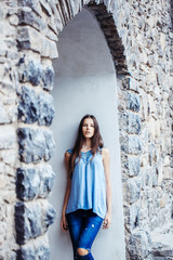 Young woman on masonry arch