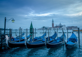Fototapeta premium Gondolad in Venice with the church San Giorgo Maggiore in the ba