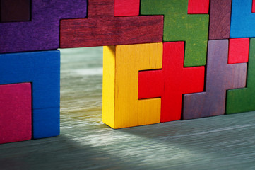 Move beyond. Glowing doorway, colorful wall of wooden puzzles. 
Move beyond meaning or definition. 