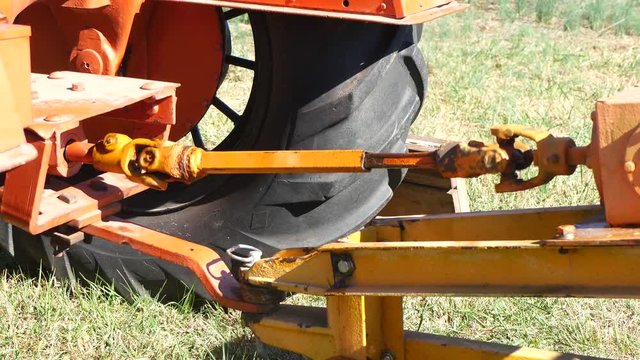 Orange Shaft With Universal Joints In Operation