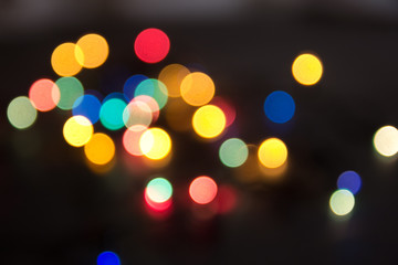 abstract lights bright on a black background, as the substrate for the holiday, unclear, vague