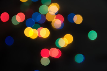 abstract lights bright on a black background, as the substrate for the holiday, unclear, vague