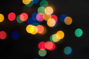 abstract lights bright on a black background, as the substrate for the holiday, unclear, vague