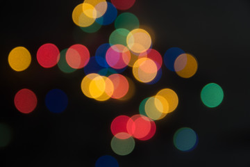 abstract lights bright on a black background, as the substrate for the holiday, unclear, vague