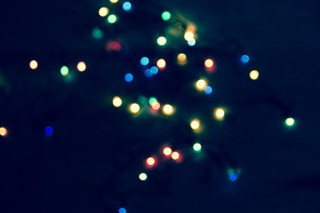 abstract lights bright on a black background, as the substrate for the holiday, unclear, vague