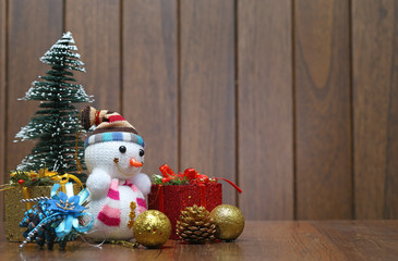 Christmas tree  gift box and snowman on wood desk