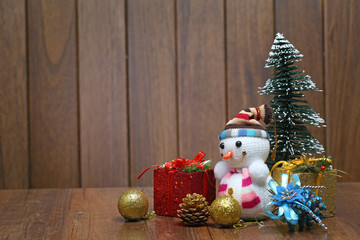 Christmas tree  gift box and snowman on wood desk